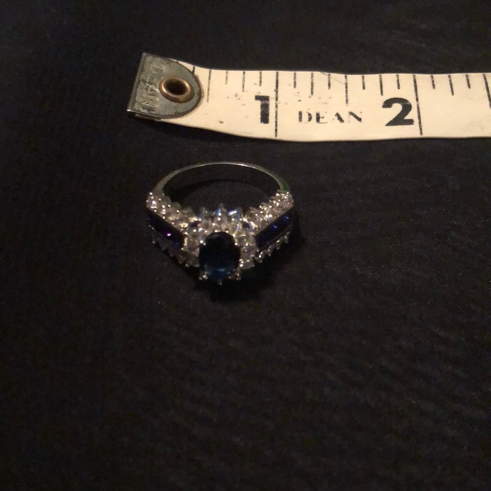 Described on purchase as 14K white gold plated ring with blue CZ